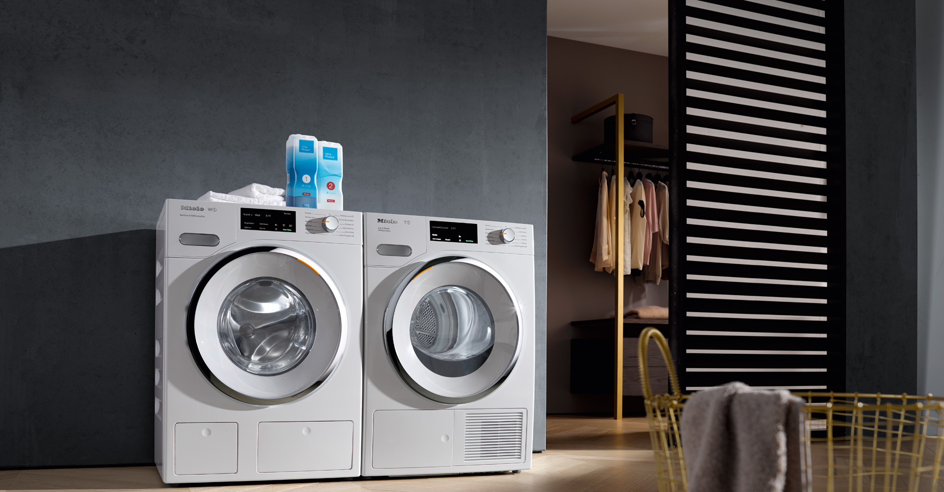 White front-load washer and dryer side by side in a modern laundry room