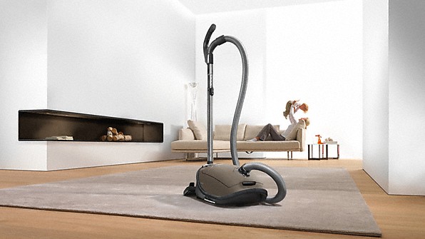 white living room with vacuum cleaner